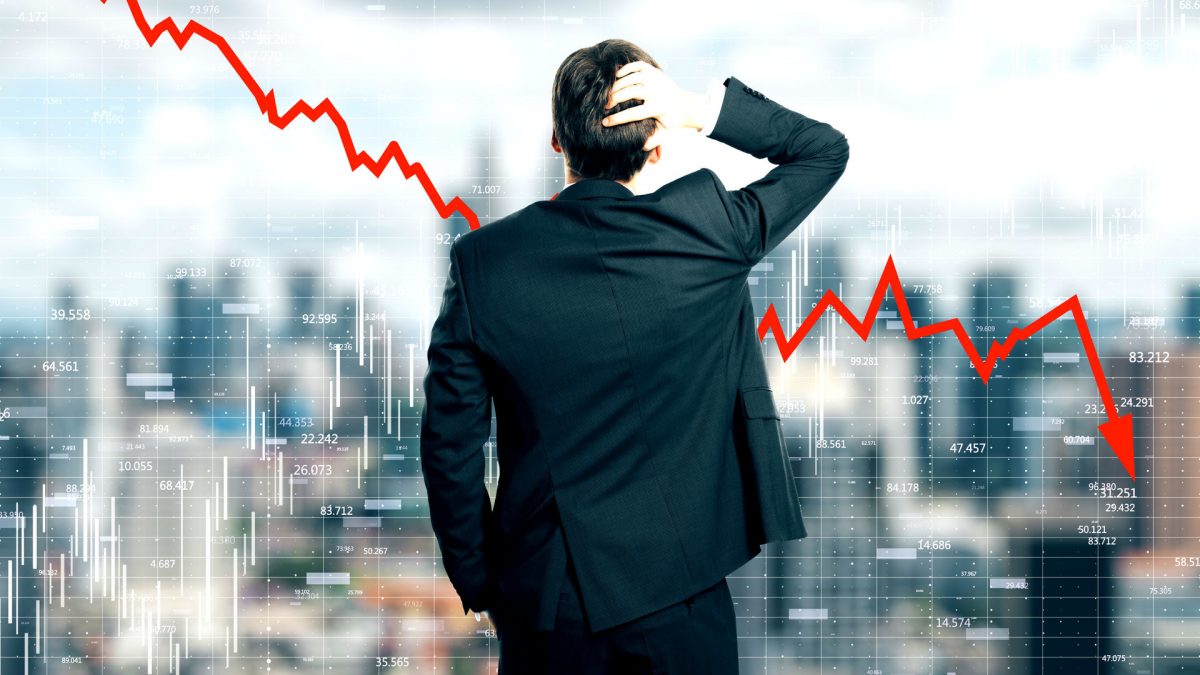 Back view of stressed young businessman looking at downward red arrow on blurry city background. Decrease, stats and economy concept. Multiexposure